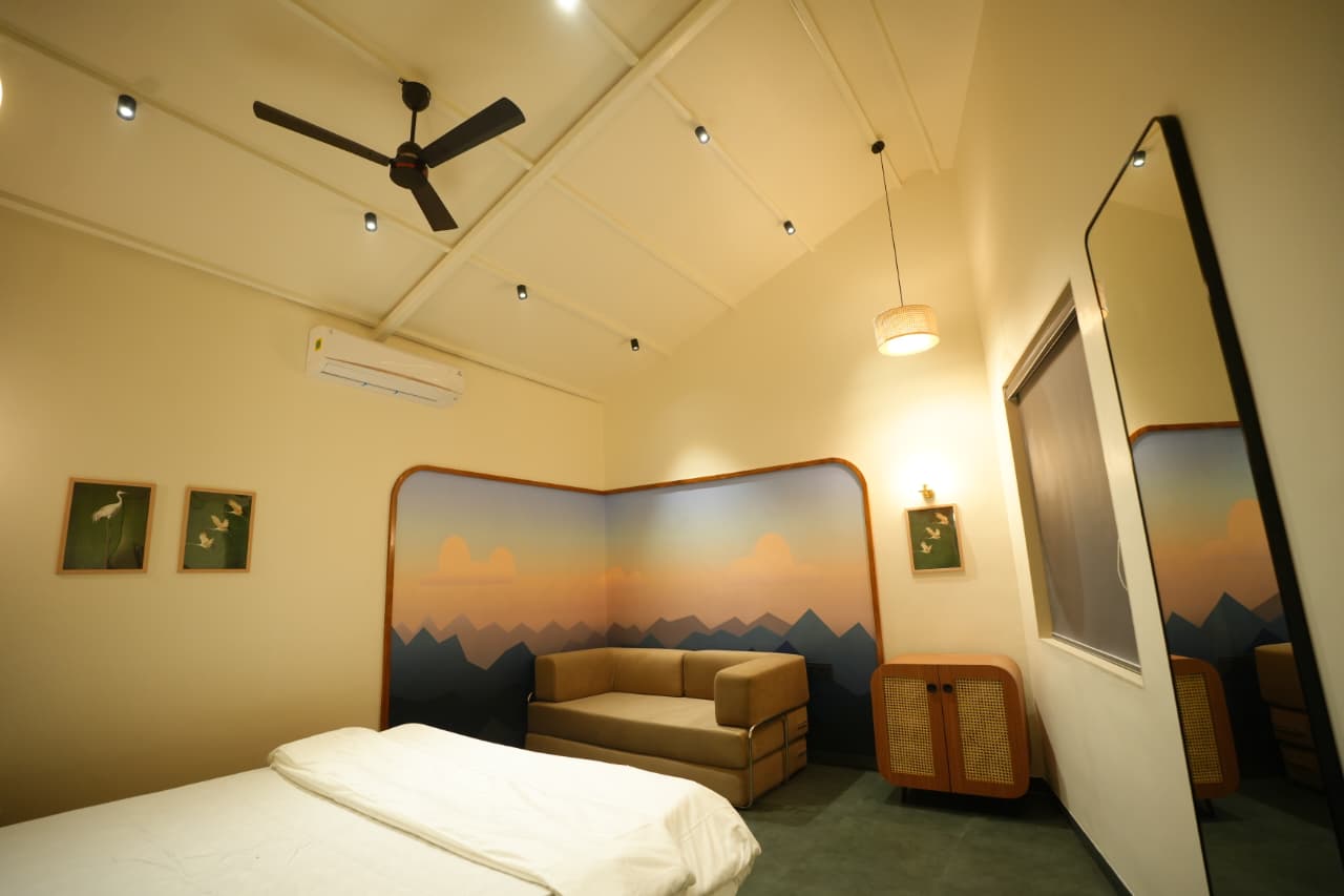 Designer bedroom with mural headboard and cane furniture