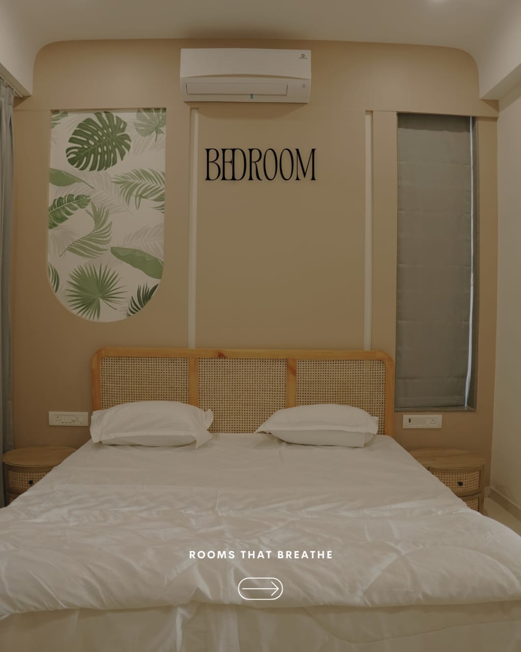 Seascape bedroom with cane headboard and tropical mural