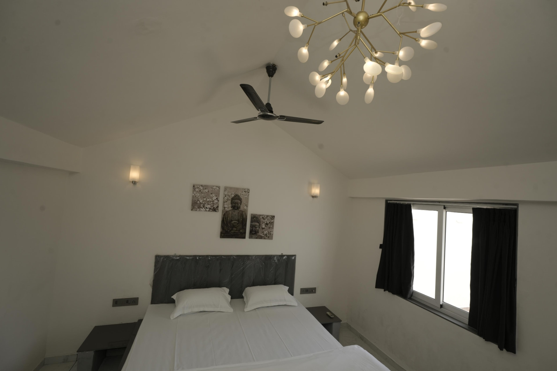 Vaulted bedroom with designer chandelier