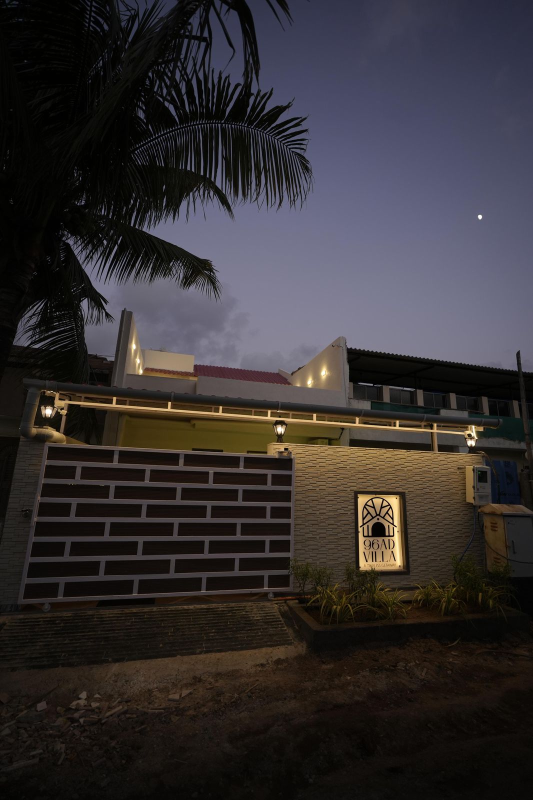 96AD Villa entrance gate illuminated at dusk